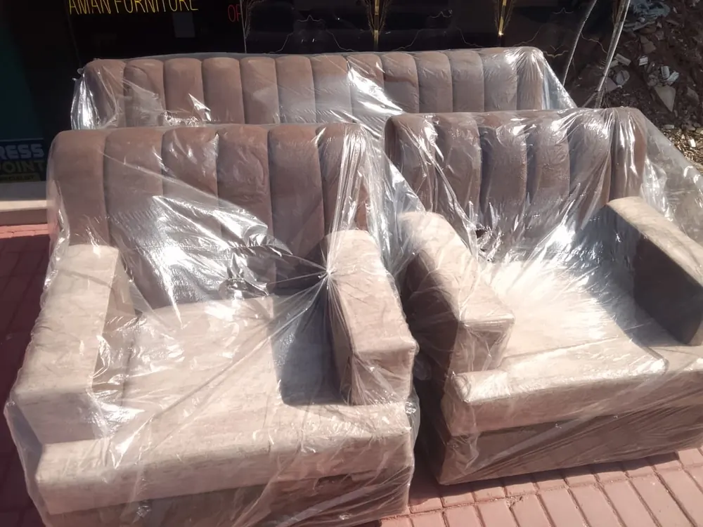 Two finished sofas wrapped in plastic