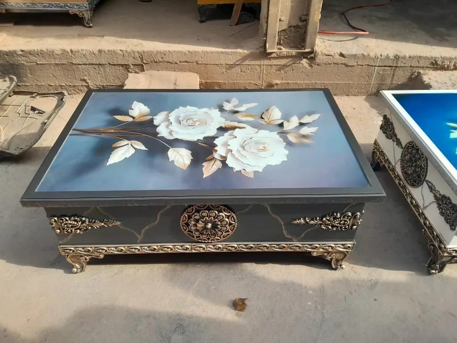 Table top with a decorative floral finish and carved gold trim